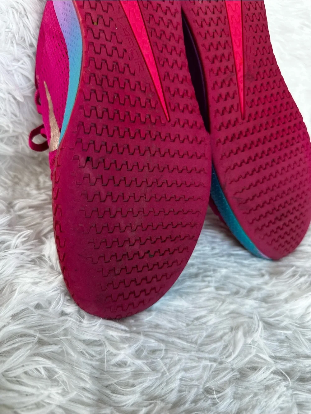 Nike Women's Bold Pink Athletic Court Shoes with Teal Purple Gradient Accent.